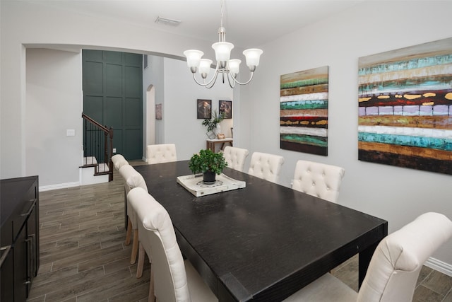 1619 Temperance Way, Wylie, TX 75098 - dining room featuring arched walkways, a chandelier, dark wood-style flooring, stairway, and baseboards