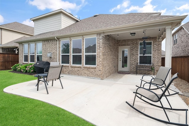 1619 Temperance Way, Wylie, TX 75098 - rear view of house with brick siding, a patio, and roof with shingles