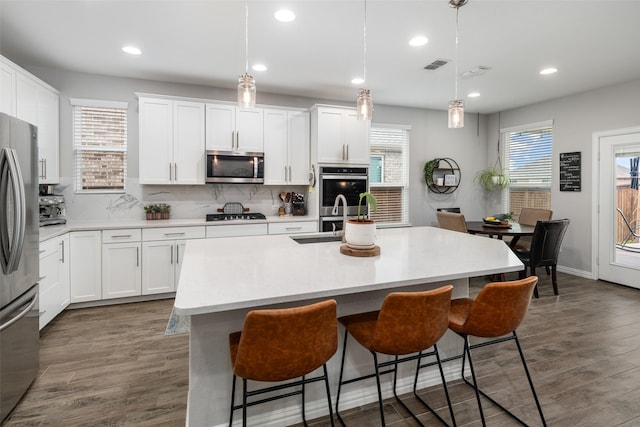1619 Temperance Way, Wylie, TX 75098 - kitchen with stainless steel appliances, a breakfast bar area, tasteful backsplash, and recessed lighting
