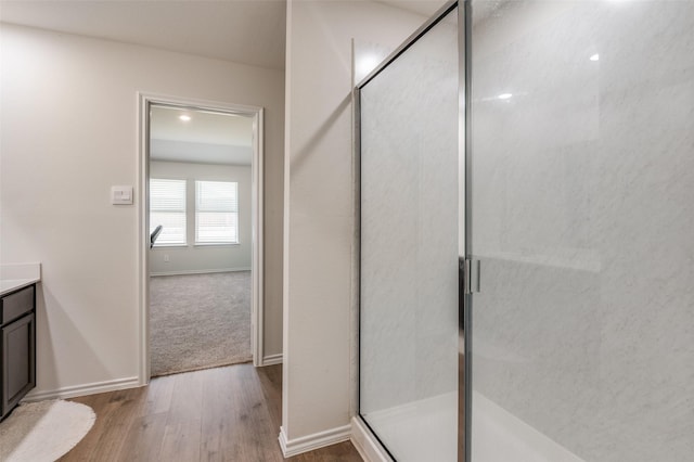 6534 Diver St, Princeton, TX 75407 - full bath featuring wood finished floors, a stall shower, vanity, and baseboards