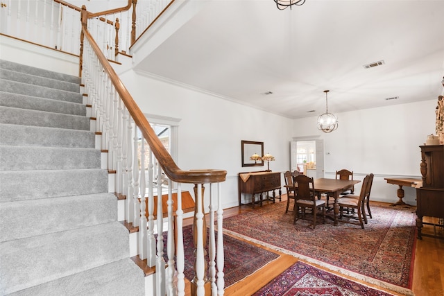 404 High Meadow Ln, Heath, TX 75032 - dining area featuring wood finished floors, stairs, a chandelier, baseboards, and crown molding