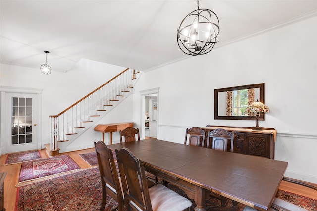 404 High Meadow Ln, Heath, TX 75032 - dining room with stairs, wood finished floors, a chandelier, ornamental molding, and baseboards