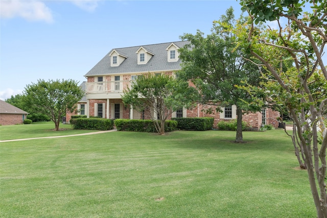 404 High Meadow Ln, Heath, TX 75032 - view of front of house with brick siding, a front lawn, and a balcony