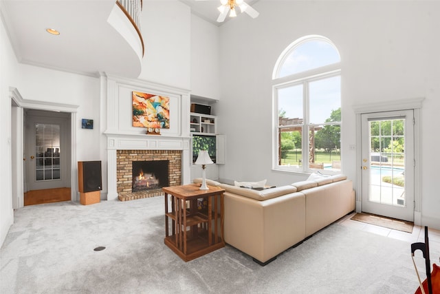 404 High Meadow Ln, Heath, TX 75032 - living room featuring a towering ceiling, a fireplace, ceiling fan, and light carpet