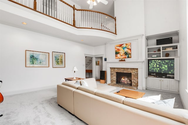 404 High Meadow Ln, Heath, TX 75032 - living area with a towering ceiling, light colored carpet, ceiling fan, a fireplace, and baseboards