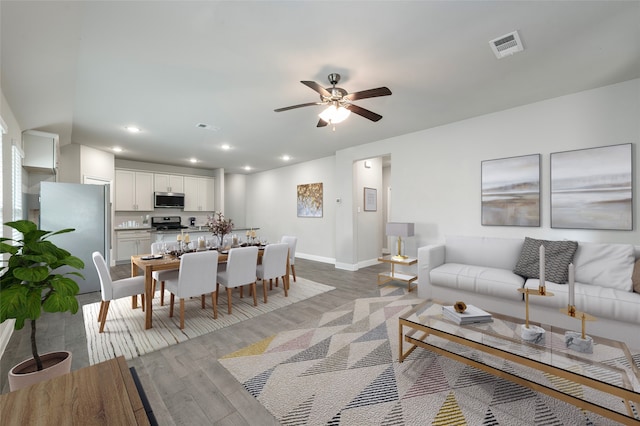 4142 Perch Dr, Forney, TX 75126 - living room featuring ceiling fan, light wood-style floors, baseboards, and recessed lighting