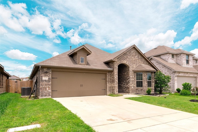 4142 Perch Dr, Forney, TX 75126 - view of front facade with brick siding, an attached garage, driveway, and cooling unit