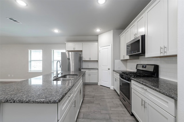 4142 Perch Dr, Forney, TX 75126 - kitchen with stainless steel appliances, a sink, recessed lighting, white cabinetry, and decorative backsplash