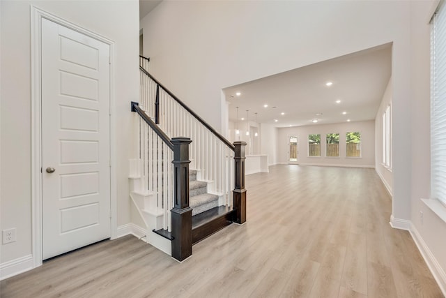 7107 Manhattan Dr, Rowlett, TX 75088 - stairway with wood finished floors, recessed lighting, and baseboards