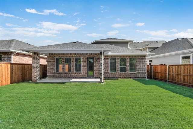 7107 Manhattan Dr, Rowlett, TX 75088 - back of property featuring brick siding, a shingled roof, and a patio