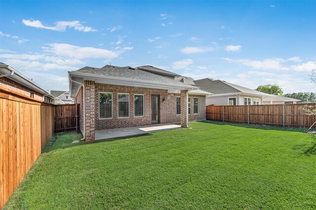 7107 Manhattan Dr, Rowlett, TX 75088 - back of house with brick siding, a shingled roof, and a patio area