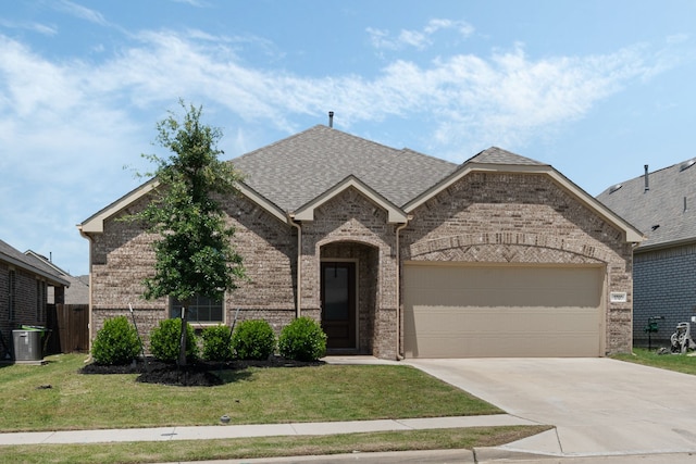 1701 Lake Grove Dr, Little Elm, TX 75068 - french country inspired facade featuring brick siding, concrete driveway, and a garage