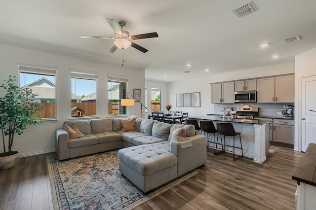 1701 Lake Grove Dr, Little Elm, TX 75068 - living room featuring dark wood-style flooring, a ceiling fan, recessed lighting, and baseboards