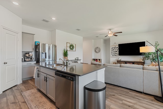 1701 Lake Grove Dr, Little Elm, TX 75068 - kitchen with appliances with stainless steel finishes, a sink, gray cabinetry, dark countertops, and ceiling fan