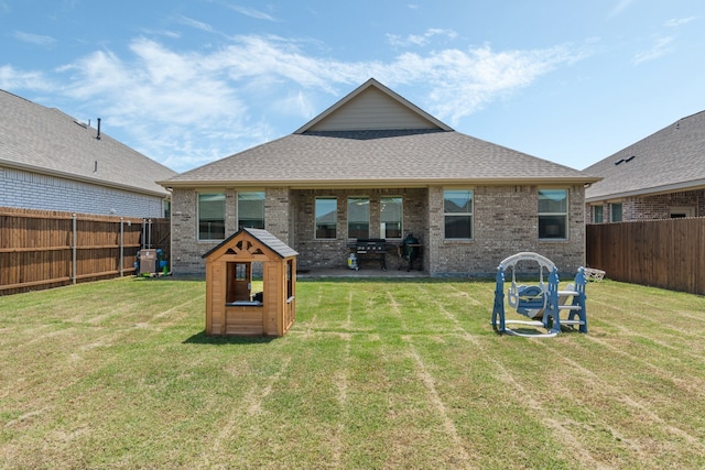 1701 Lake Grove Dr, Little Elm, TX 75068 - back of house with brick siding and roof with shingles