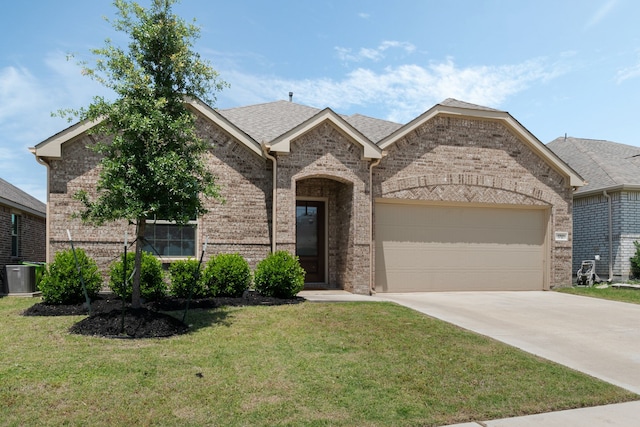 1701 Lake Grove Dr, Little Elm, TX 75068 - french country style house with brick siding, a garage, central AC, and driveway