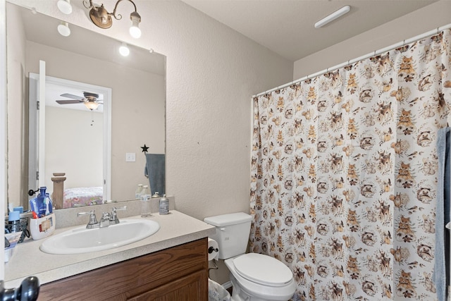 295 Lindsey Ln, Stephenville, TX 76401 - bathroom featuring ceiling fan, toilet, vanity, a textured wall, and curtained shower
