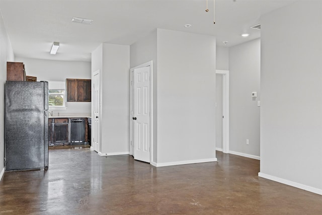 295 Lindsey Ln, Stephenville, TX 76401 - unfurnished living room featuring finished concrete floors and baseboards