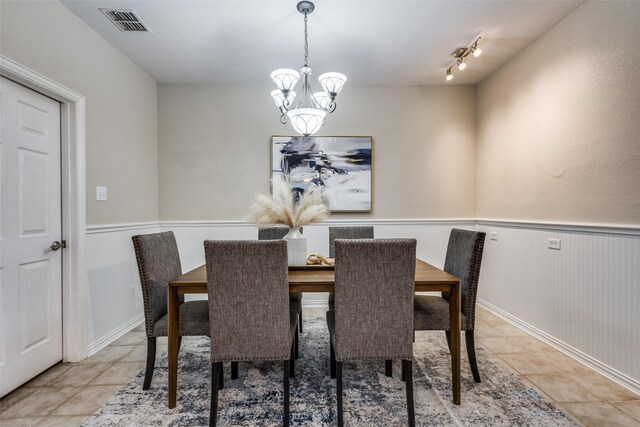 851 Sibyl Ln, Prosper, TX 75078 - dining space with light tile patterned flooring, a chandelier, and wainscoting