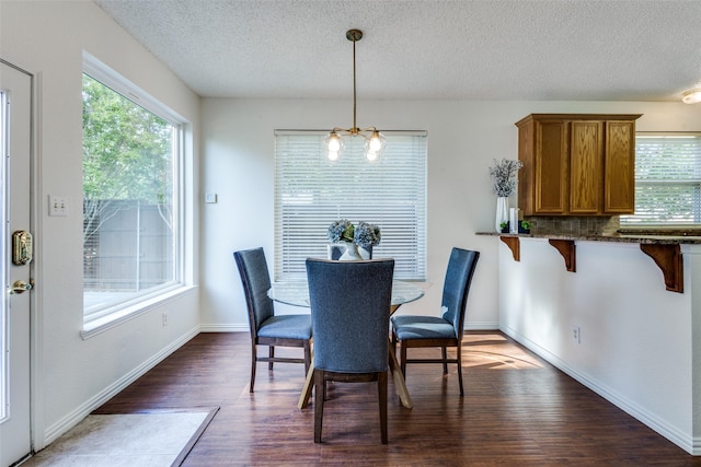 3717 Drew Dr, Frisco, TX 75035 - dining area with dark wood finished floors, a textured ceiling, baseboards, and a chandelier