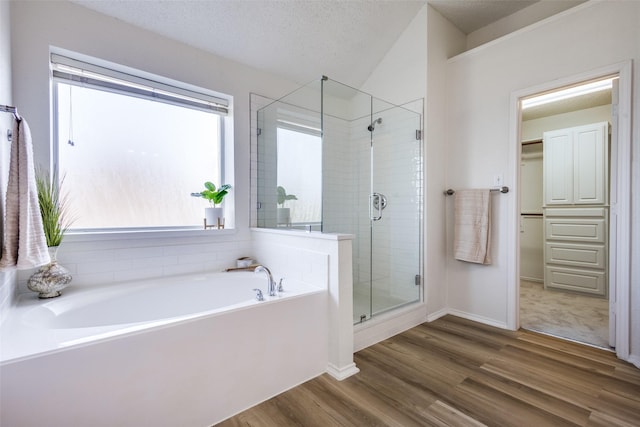 3717 Drew Dr, Frisco, TX 75035 - bathroom featuring a shower stall, wood finished floors, a garden tub, baseboards, and lofted ceiling