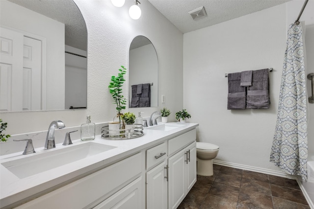 3717 Drew Dr, Frisco, TX 75035 - bathroom with toilet, a textured ceiling, double vanity, and baseboards
