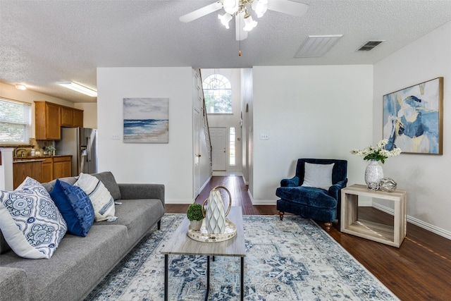 3717 Drew Dr, Frisco, TX 75035 - living room with a textured ceiling, dark wood finished floors, a ceiling fan, and baseboards