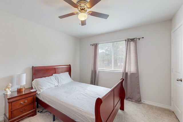 7448 Crossfire Trl, Fort Worth, TX 76112 - bedroom with light colored carpet, a ceiling fan, and baseboards