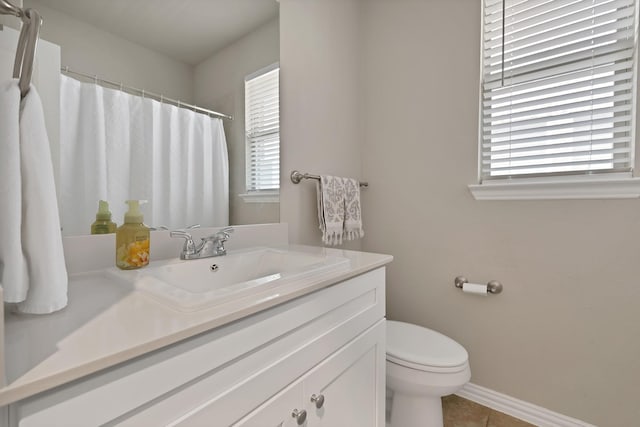 3935 Chesapeake Ln, Crandall, TX 75114 - bathroom featuring plenty of natural light, toilet, tile patterned floors, and vanity
