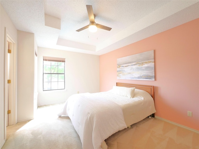 4541 Salerno Cir, Plano, TX 75093 - bedroom featuring carpet floors, a raised ceiling, a textured ceiling, baseboards, and ceiling fan
