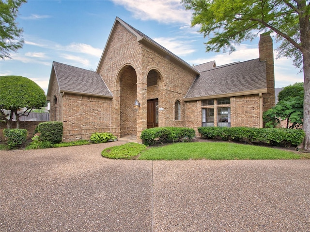 4541 Salerno Cir, Plano, TX 75093 - view of front of house with brick siding, a shingled roof, a chimney, and fence