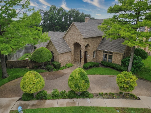 4541 Salerno Cir, Plano, TX 75093 - french country home featuring brick siding, fence, a chimney, and roof with shingles