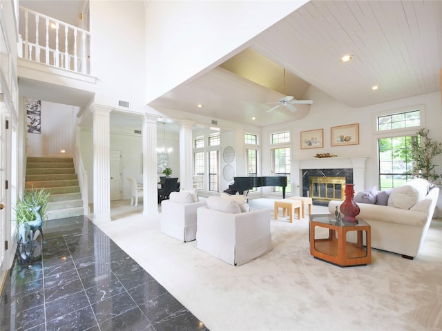 4541 Salerno Cir, Plano, TX 75093 - living room with a ceiling fan, decorative columns, high vaulted ceiling, a fireplace, and marble tiled flooring