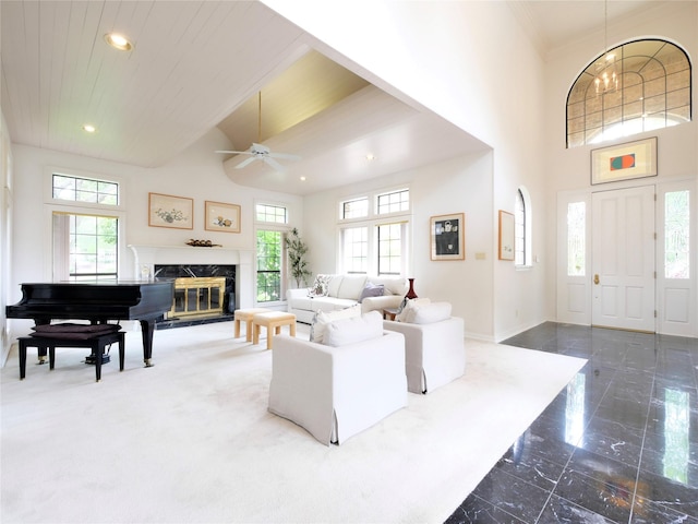 4541 Salerno Cir, Plano, TX 75093 - living room featuring a ceiling fan, dark marble finish flooring, a high ceiling, recessed lighting, and a premium fireplace