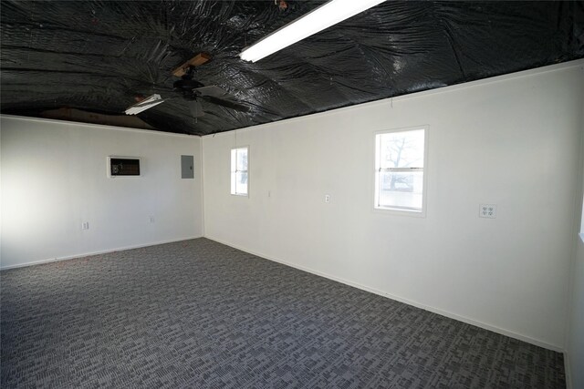 2409 Sunset Ln, Burleson, TX 76028 - basement with ceiling fan, electric panel, plenty of natural light, and dark carpet