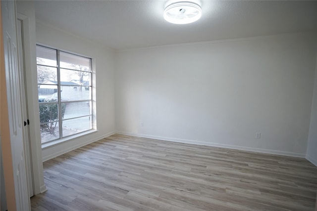 2409 Sunset Ln, Burleson, TX 76028 - empty room featuring light wood-type flooring, baseboards, and crown molding