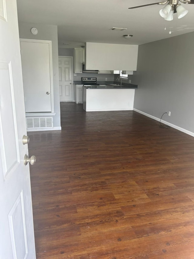 209 Joyce St, Weatherford, TX 76085 - kitchen with dark countertops, a ceiling fan, baseboards, and dark wood-style floors