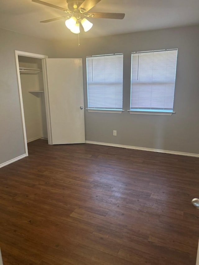 209 Joyce St, Weatherford, TX 76085 - unfurnished bedroom featuring dark wood-style flooring, baseboards, a closet, and a ceiling fan