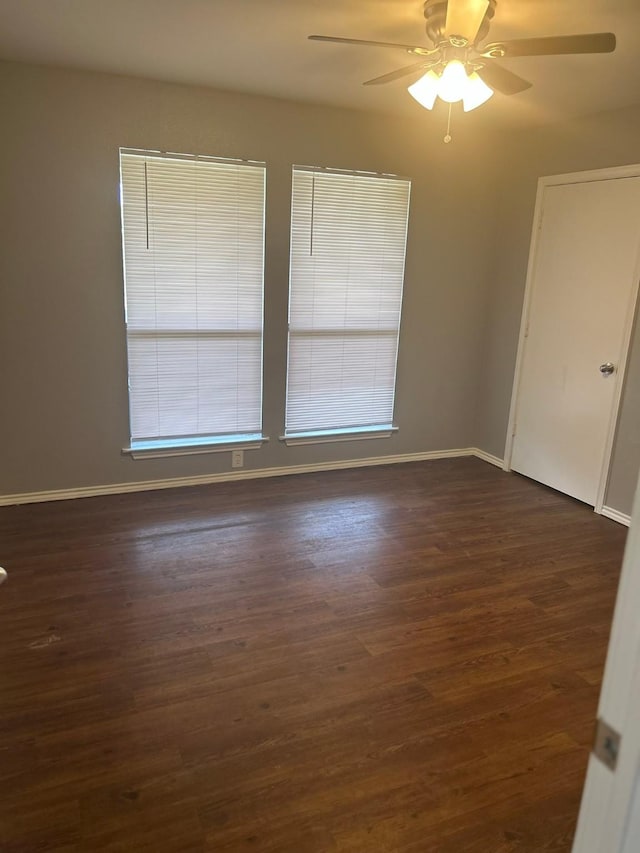 205 Joyce St, Weatherford, TX 76085 - empty room with a ceiling fan, dark wood-style flooring, and baseboards
