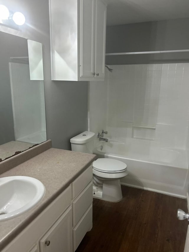 205 Joyce St, Weatherford, TX 76085 - full bathroom with toilet, wood finished floors, vanity, and tub / shower combination