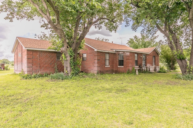 109 Honeysuckle, Paradise, TX 76073 - rear view of property featuring brick siding, a yard, and a shingled roof