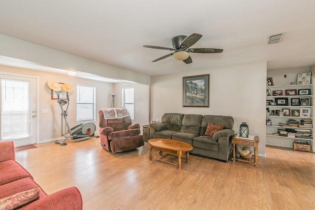 109 Honeysuckle, Paradise, TX 76073 - living area with light wood-style floors and a ceiling fan
