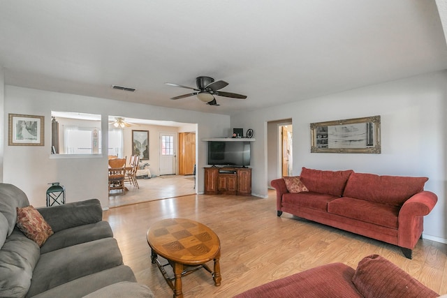 109 Honeysuckle, Paradise, TX 76073 - living area featuring ceiling fan and light wood-style floors