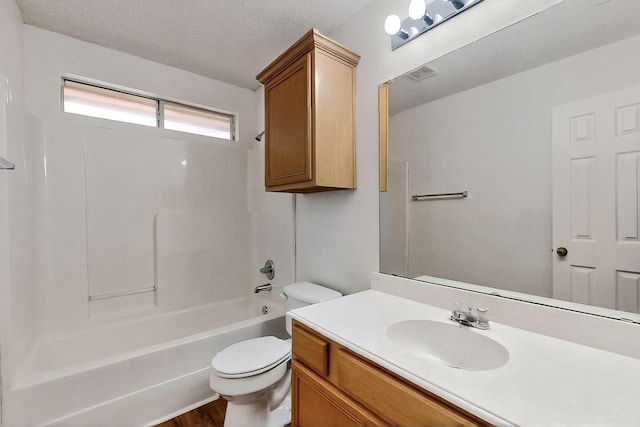 232 Cotton Wood Ct, Rockwall, TX 75032 - bathroom with toilet, vanity, shower / washtub combination, and a textured ceiling