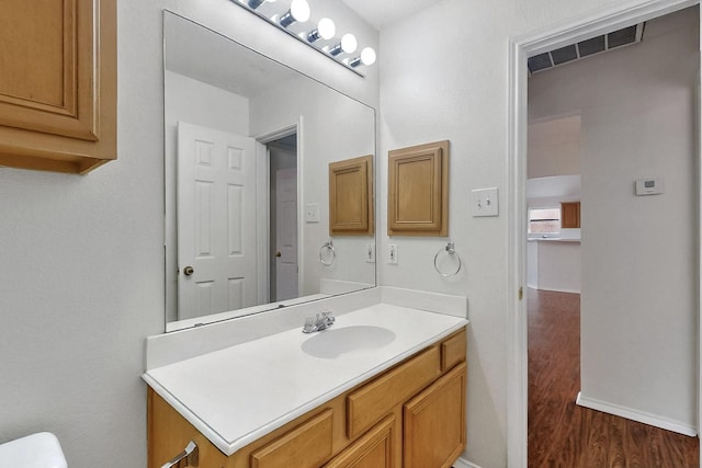232 Cotton Wood Ct, Rockwall, TX 75032 - half bath featuring wood finished floors, vanity, baseboards, and toilet