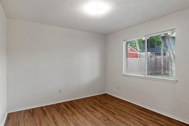 232 Cotton Wood Ct, Rockwall, TX 75032 - spare room featuring wood finished floors, baseboards, and a textured ceiling