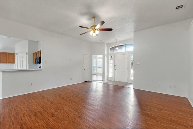 232 Cotton Wood Ct, Rockwall, TX 75032 - unfurnished living room with ceiling fan, wood finished floors, baseboards, and a textured ceiling