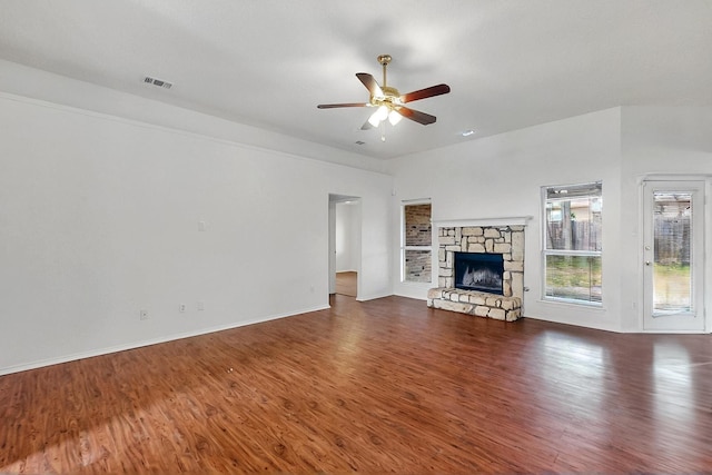 232 Cotton Wood Ct, Rockwall, TX 75032 - unfurnished living room with ceiling fan, dark wood-type flooring, baseboards, and a stone fireplace