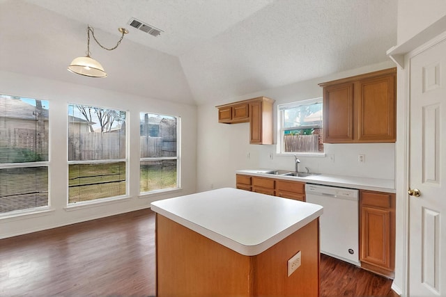 232 Cotton Wood Ct, Rockwall, TX 75032 - kitchen featuring dishwasher, a sink, dark wood-style floors, a kitchen island, and brown cabinets