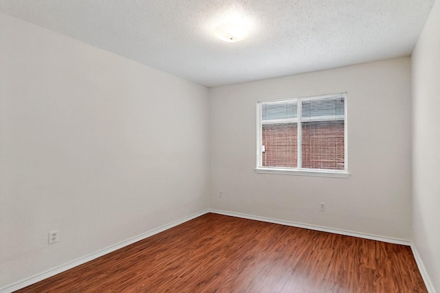 232 Cotton Wood Ct, Rockwall, TX 75032 - unfurnished room with wood finished floors, baseboards, and a textured ceiling